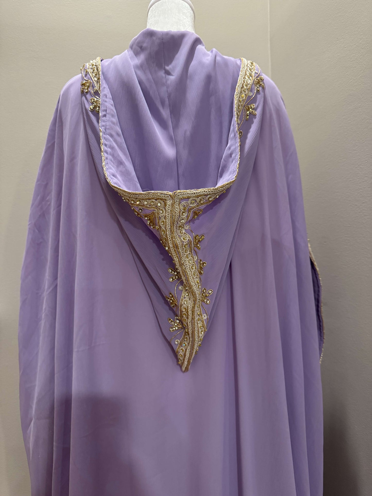 Close-up of hand-placed crystal details on lavender kaftan fabric