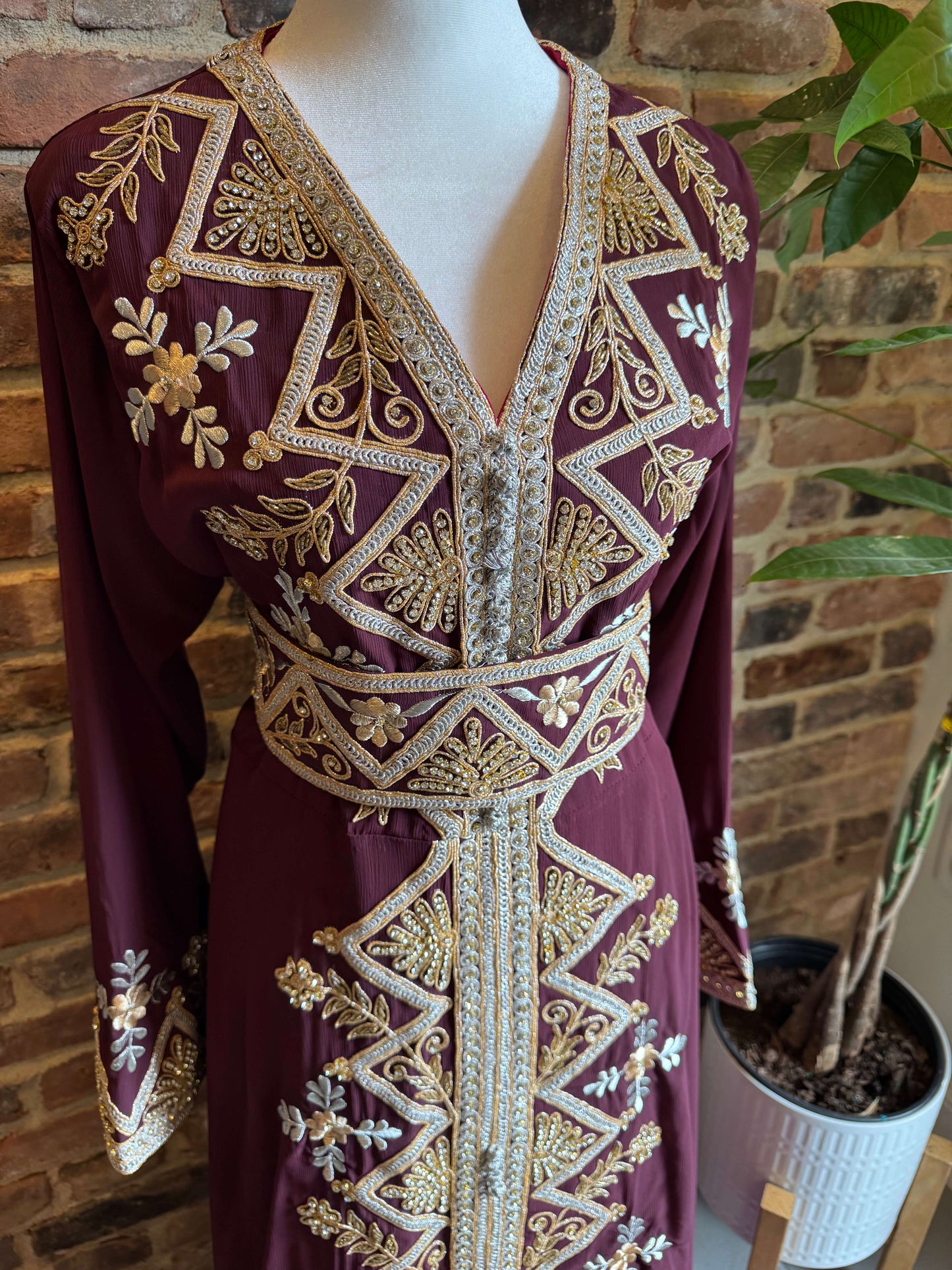Close-up of embroidery detail on burgundy luxury kaftan dress – rich stitching for special occasions