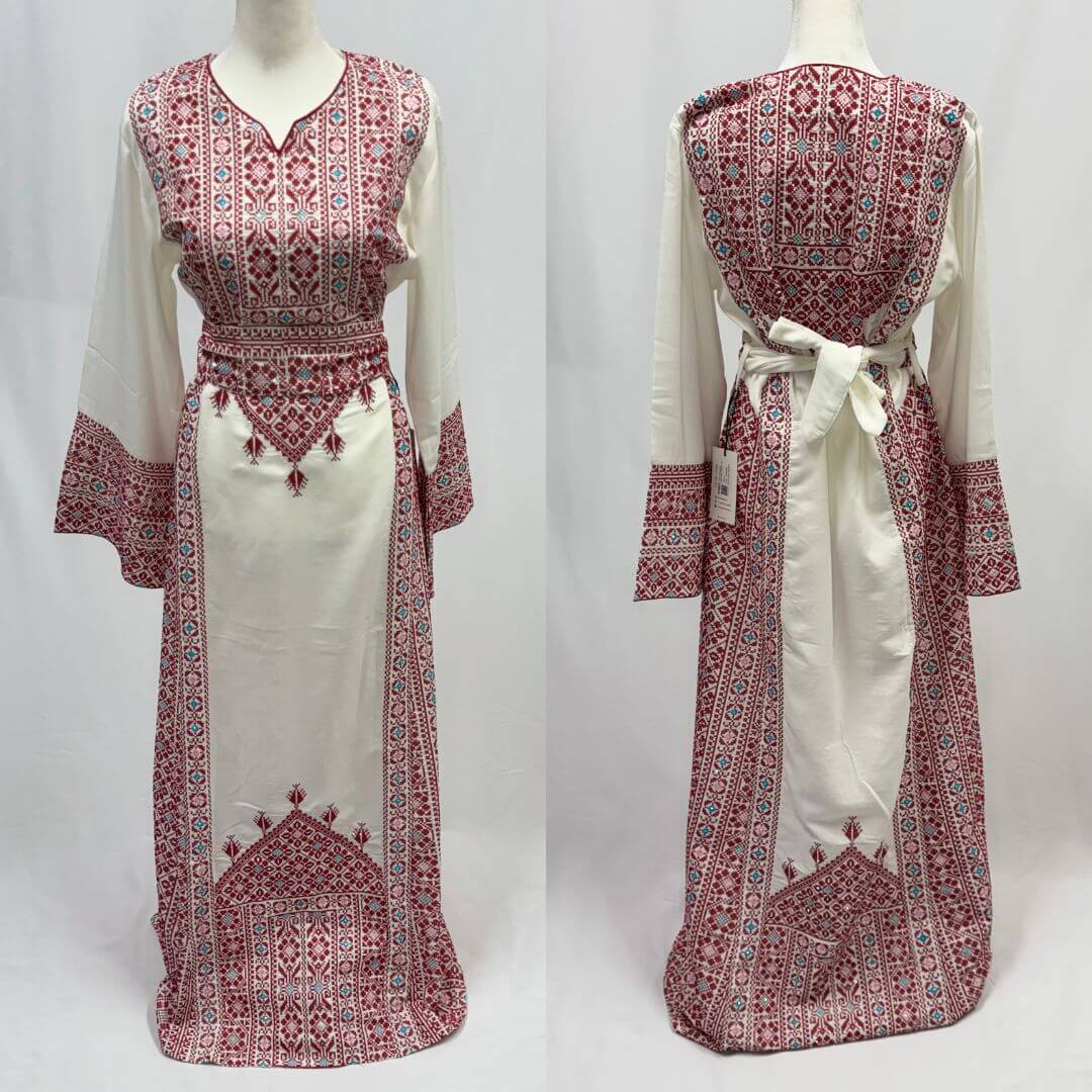 White dress with red and blue intricate patterns on a white background
